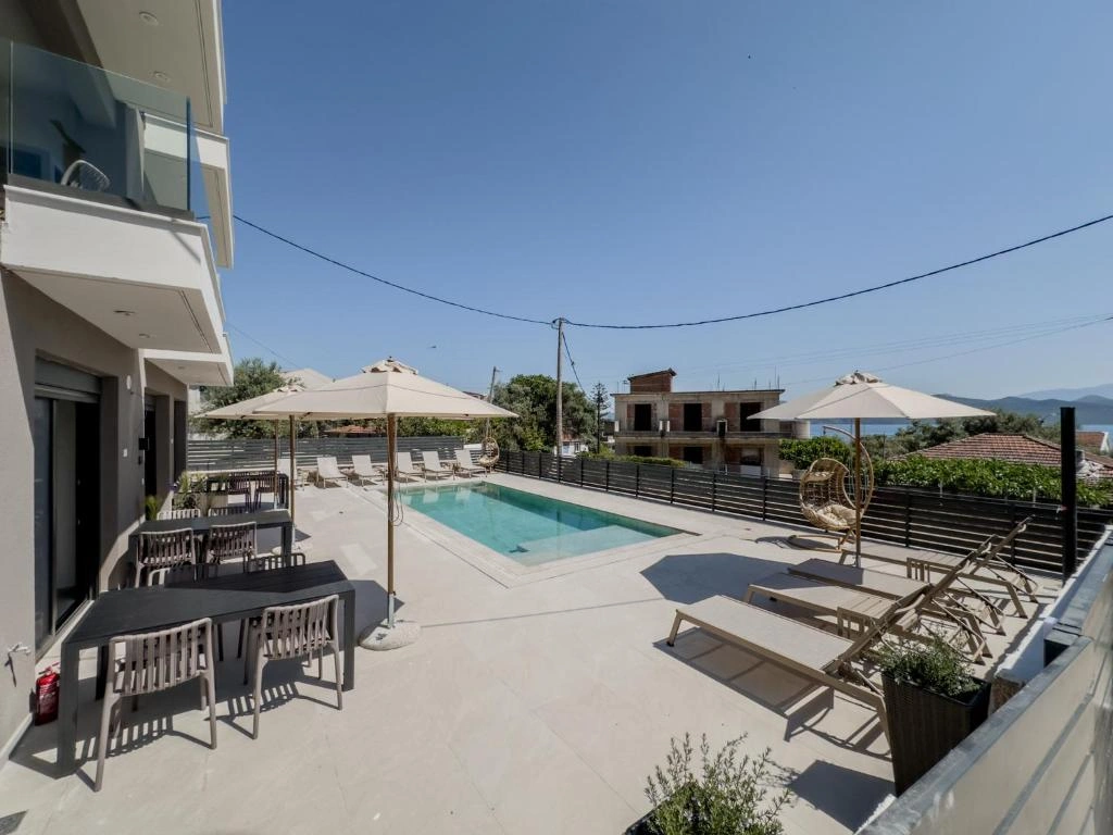 Night view of the illuminated pool and suites